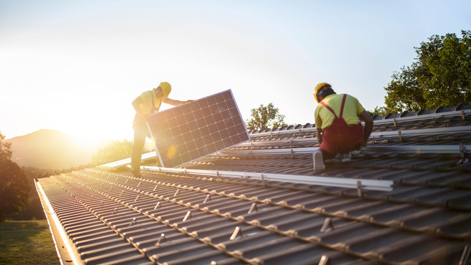 Workers install solar panels on the roof of a house. File pic: iStock