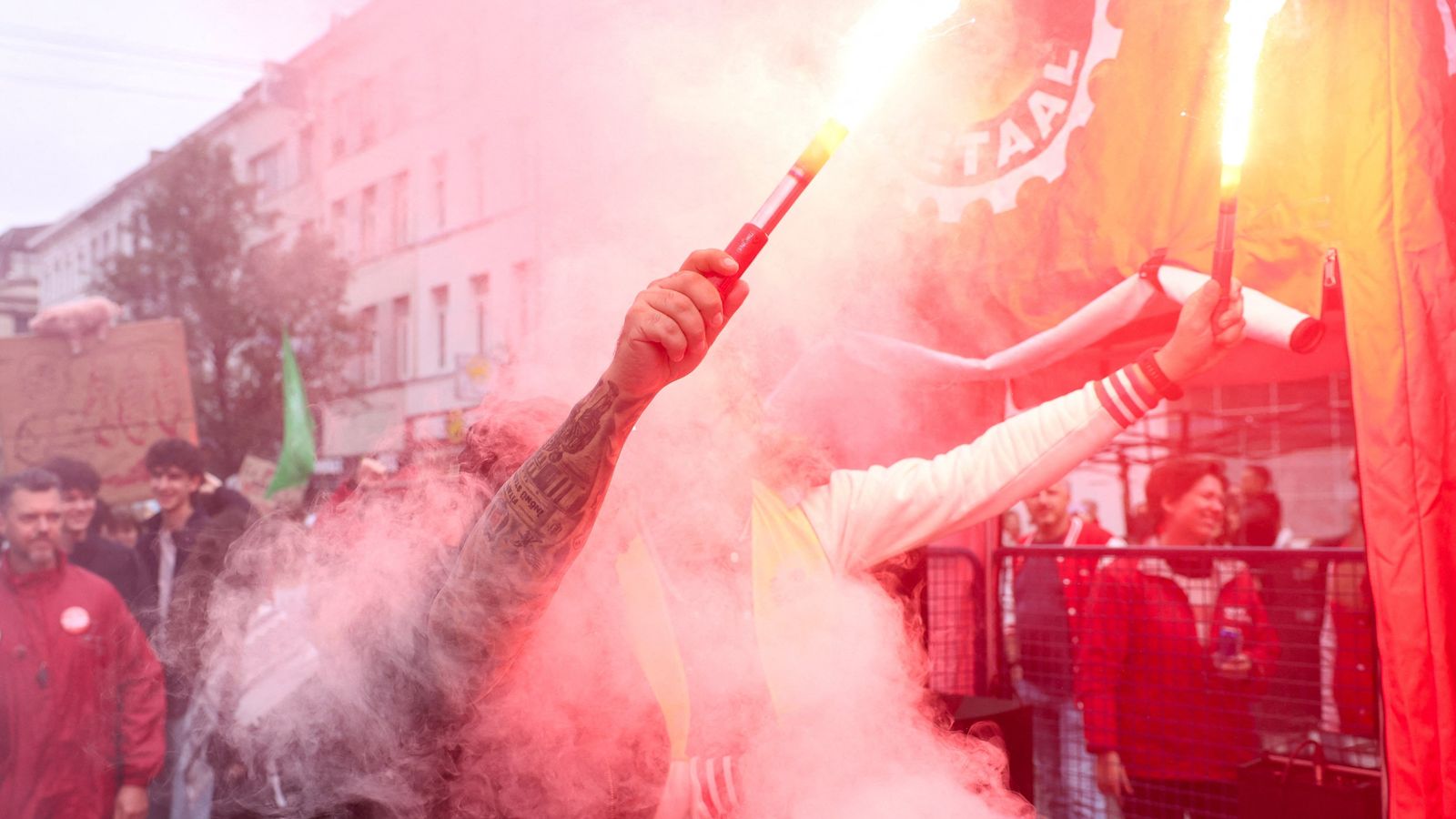 Protesters hold flares at a demonstration in Brussels. Pic: Reuters