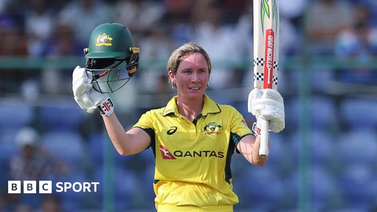 Beth Mooney of Australia raises her bat