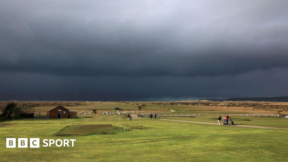 Golfers walk to the clubhouse from the 18th green in Bideford