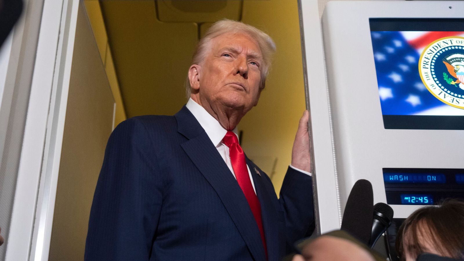 US President Donald Trump talking to reporters on Air Force One. Pic: AP