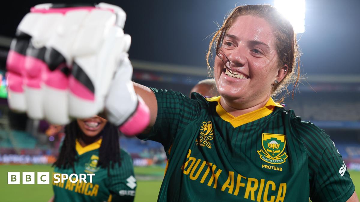 Nadine de Klerk fist-pumps a team-mate with a smile on her face