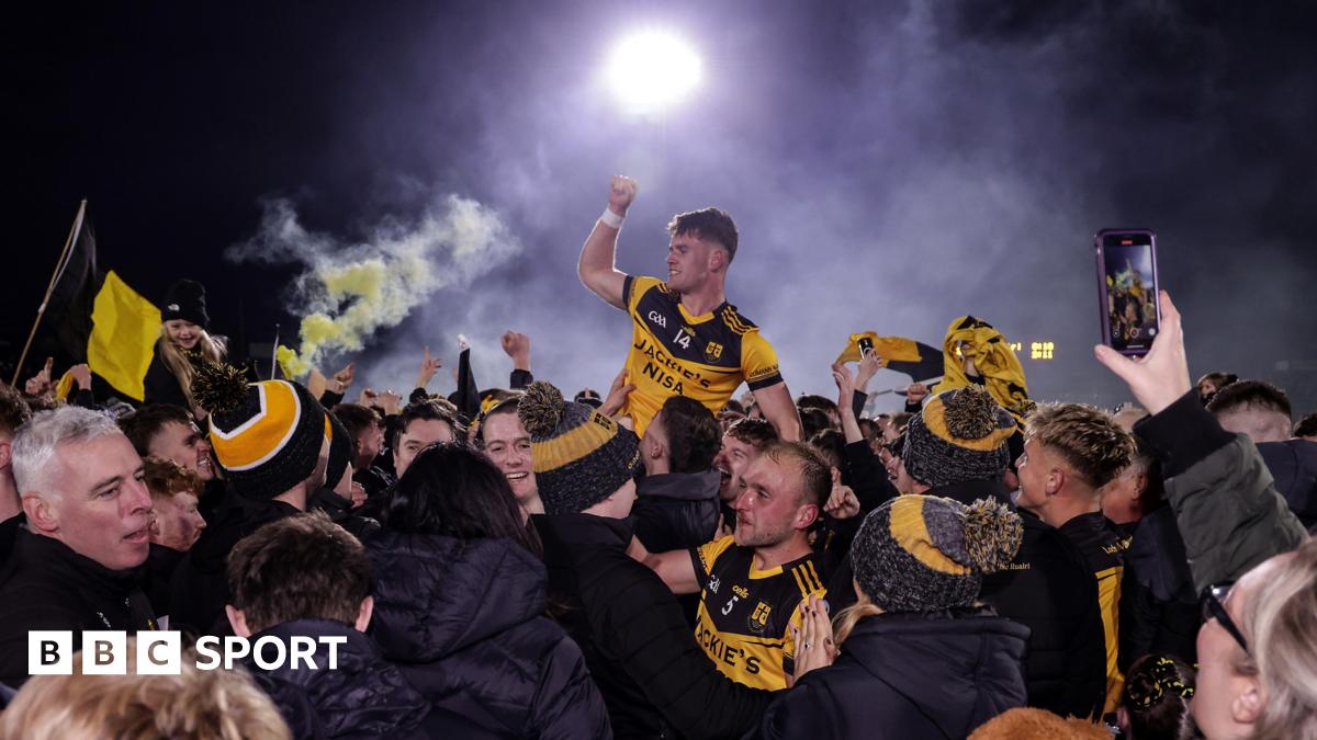 Ruairi McCullagh celebrates winning the Tyrone title with fans on the Healy Park pitch.