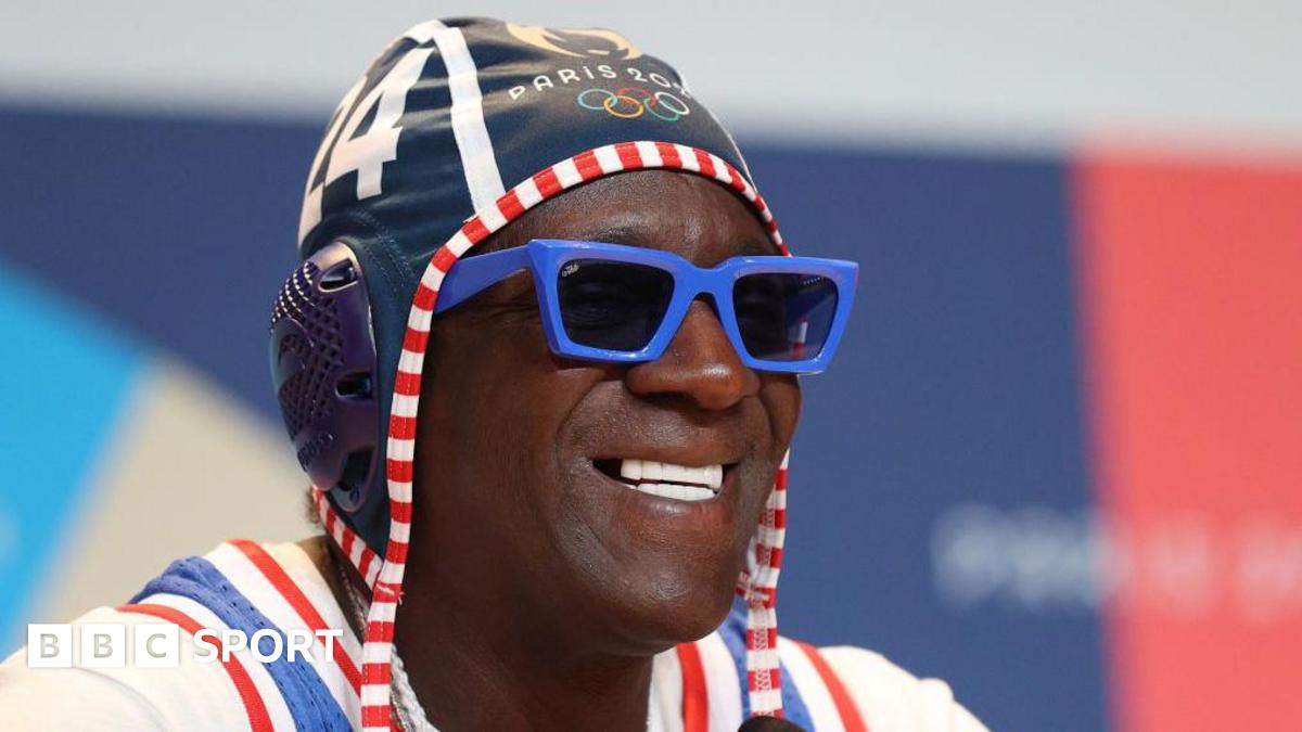 Rapper Flavor Flav wearing an Olympic hat