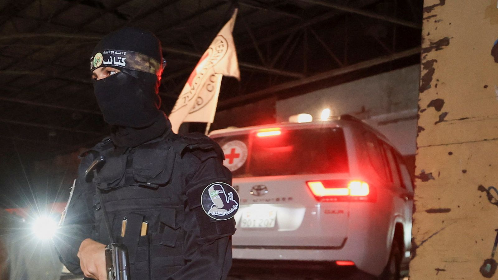 A Hamas militant as a Red Cross vehicle arrives in Gaza City to receive the bodies of hostages. Pic: Reuters