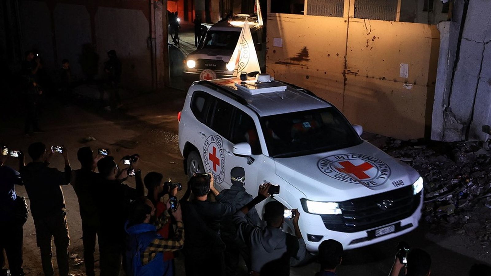 Red Cross vehicles collect coffins from Gaza on Tuesday evening. Pic: Reuters