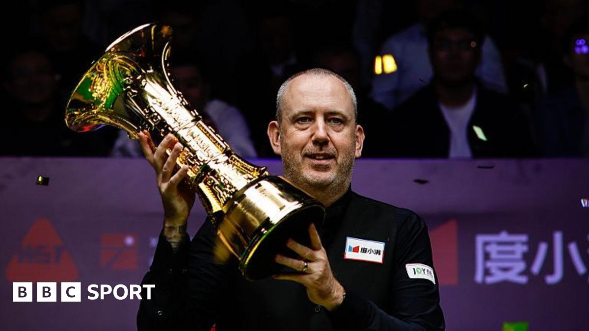 Mark Williams celebrates with the trophy