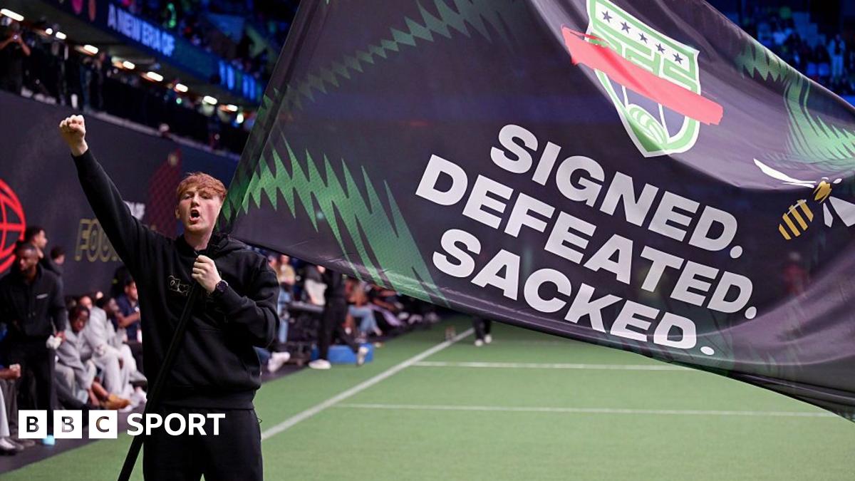 AngryGinge holds a flag that reads 'Signed. Defeated. Sacked'.