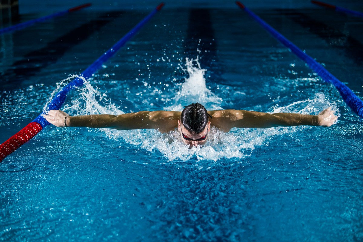 man swimming the butterfly stroke
