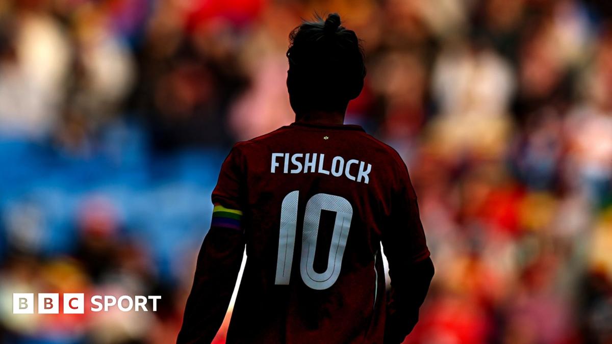 Jess Fishlock's back, showing her name and number, with the Wales crowd in the distance