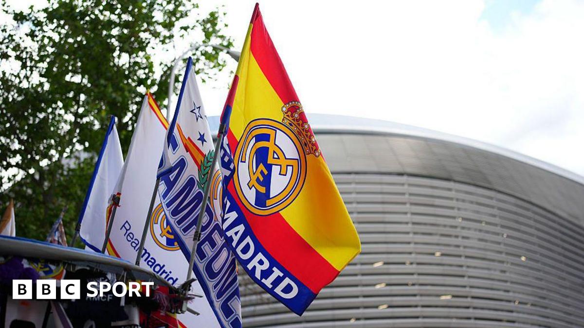 A row of Spain and Real Madrid flags fly in front of the Bernabeu stadium