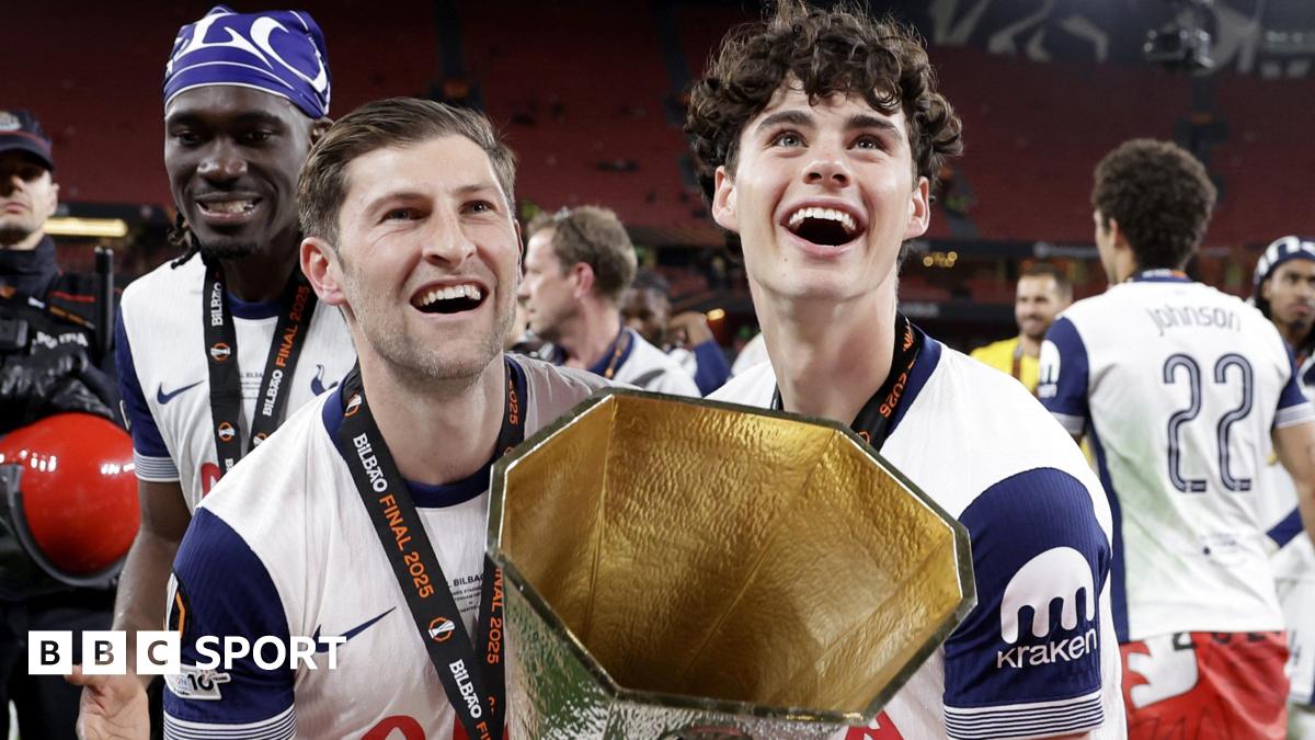 Ben Davies and Archie Gray lift the Europa League trophy
