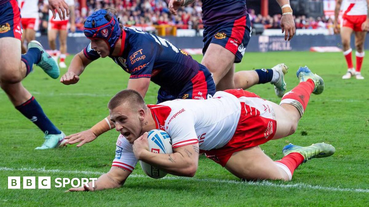 Hull KR player Mikey Lewis dives over the line to score a