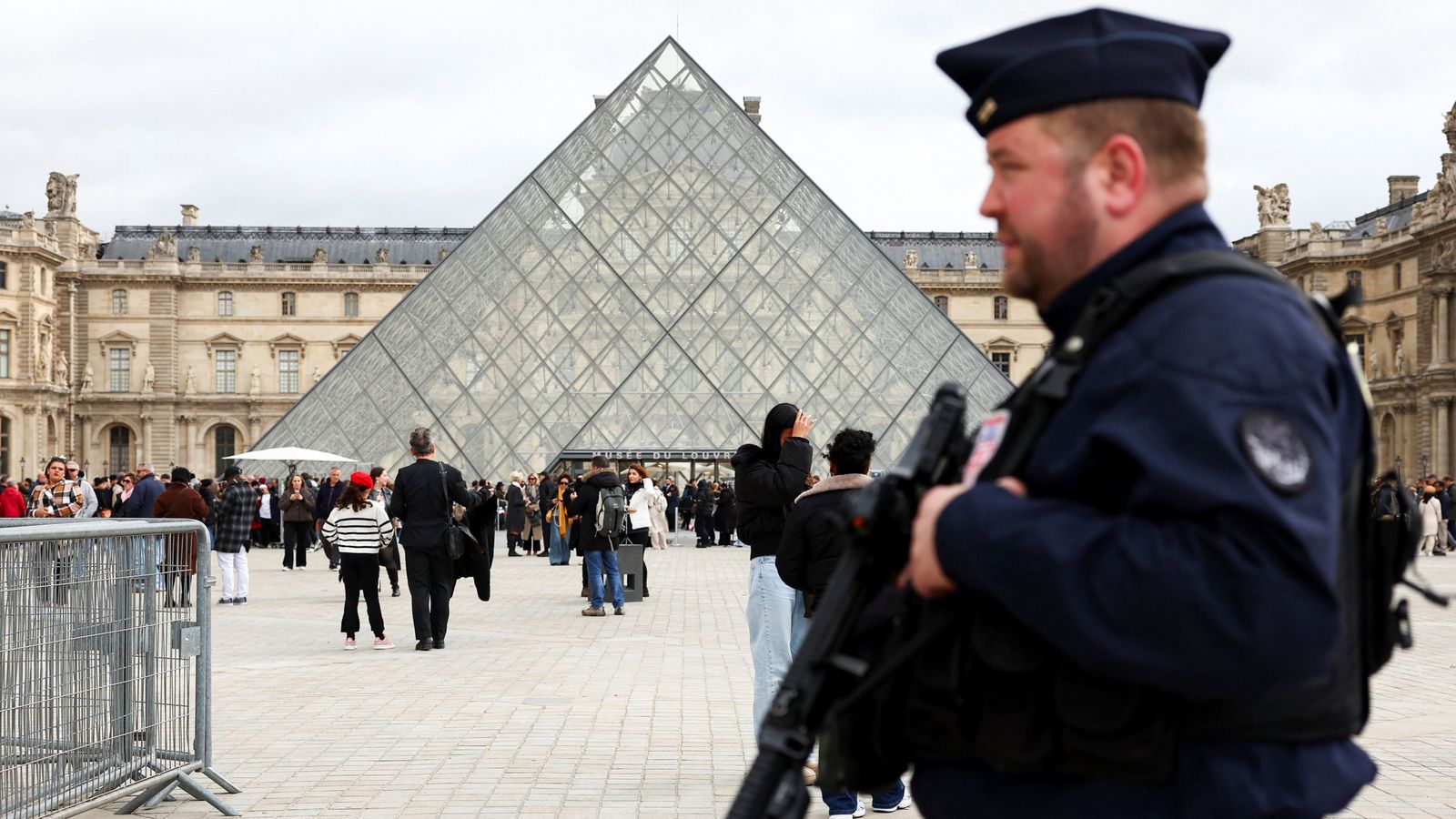 A French CRS riot police officer patrols near the glass pyramid of the Louvre on 27 October 2025. Pic: Reuters