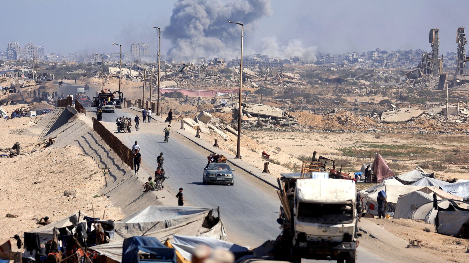 Smoke rises as displaced Palestinians fled northern Gaza on Tuesday. Pic: Reuters