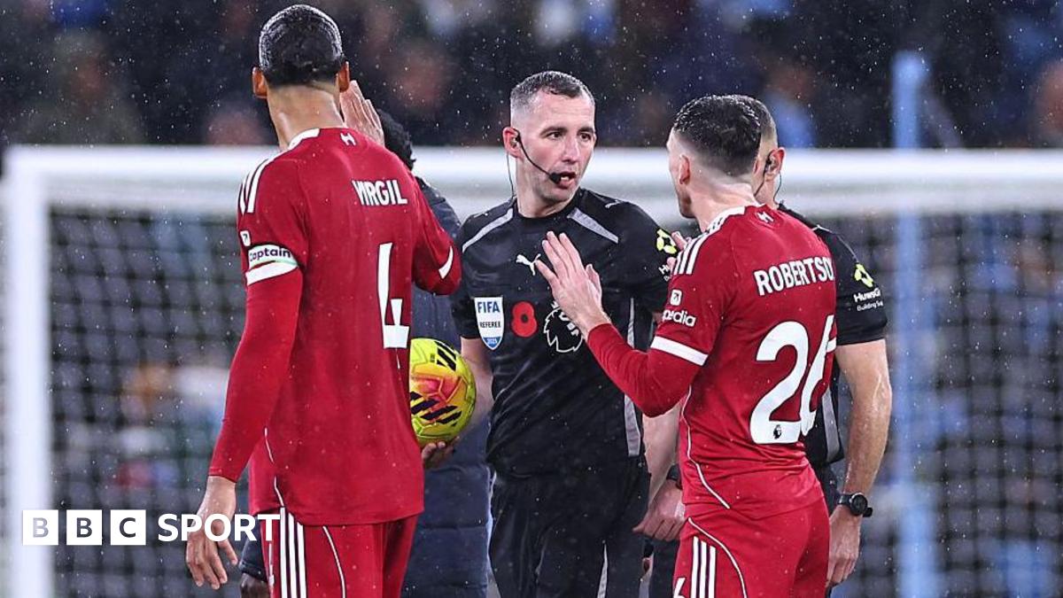 Andrew Robertson of Liverpool speaks with referee Chris Kavanagh.