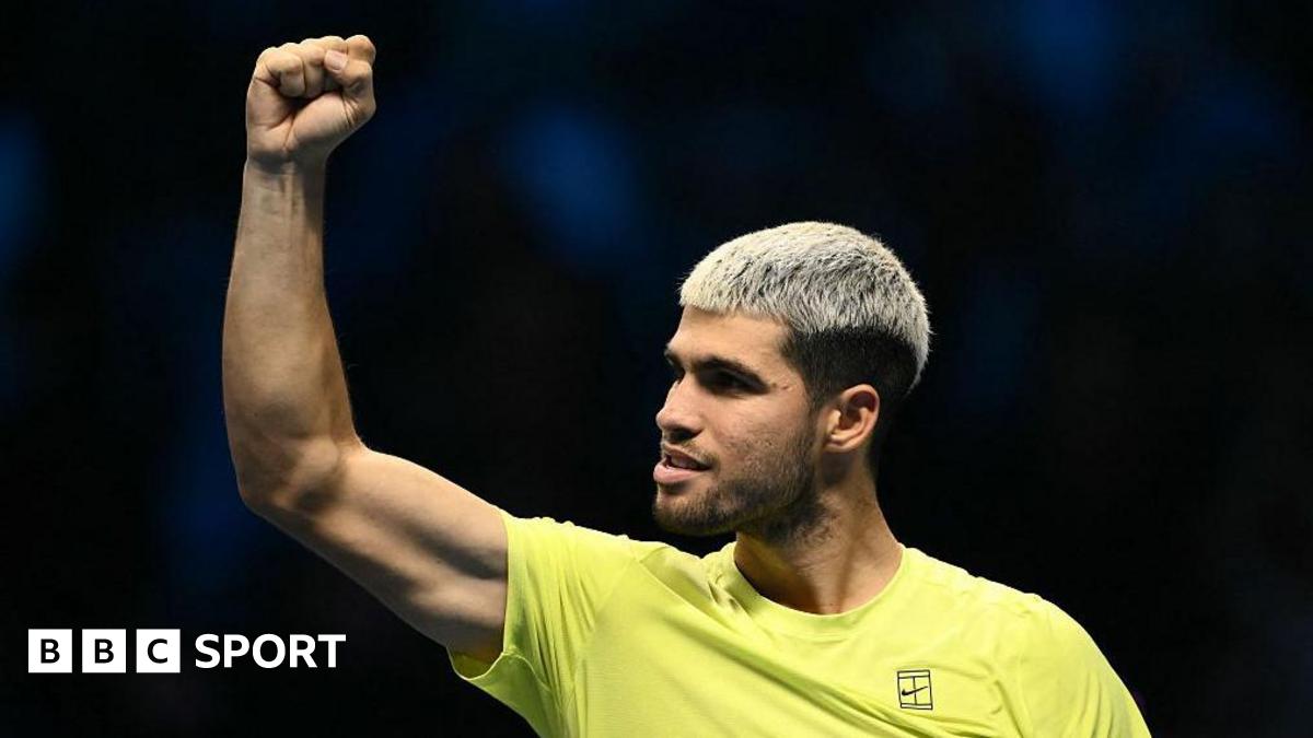 Carlos Alcaraz raises his right arm in celebration