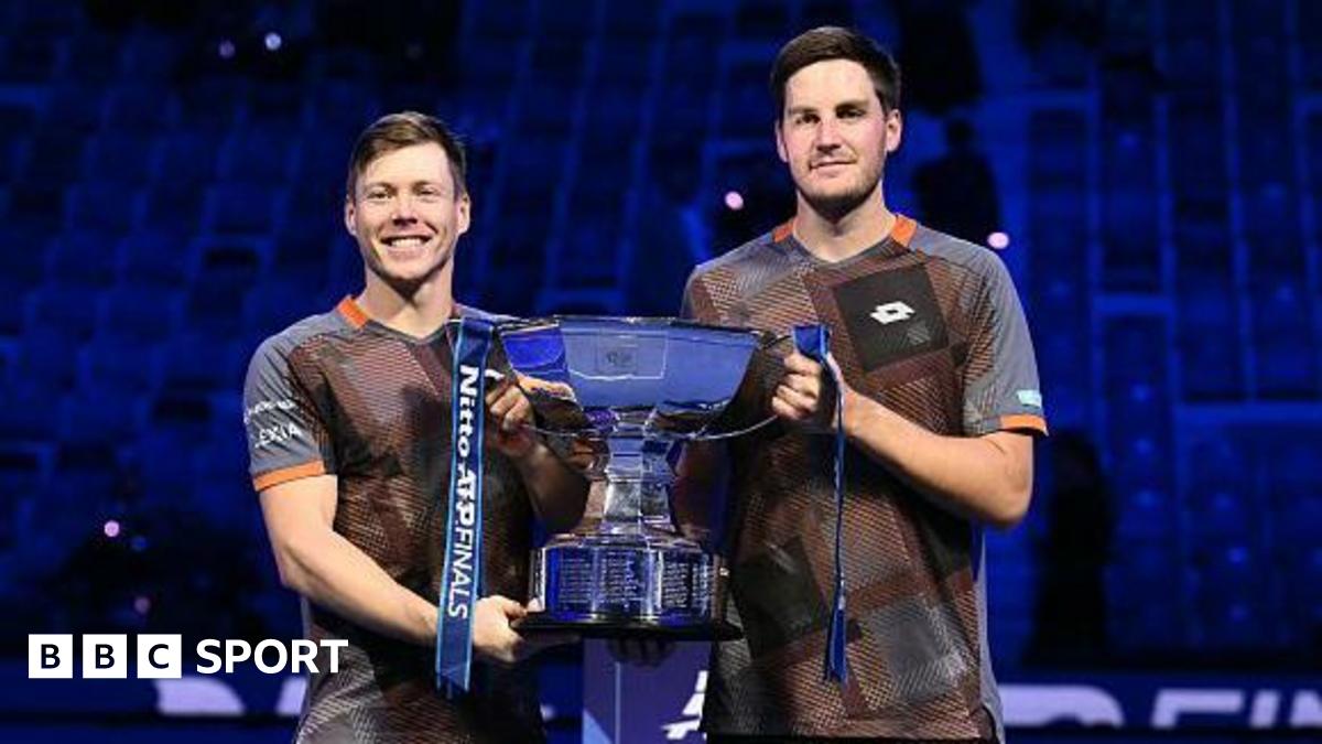 Harri Heliovaara and Henry Patten celebrate with the ATP Finals doubles trophy