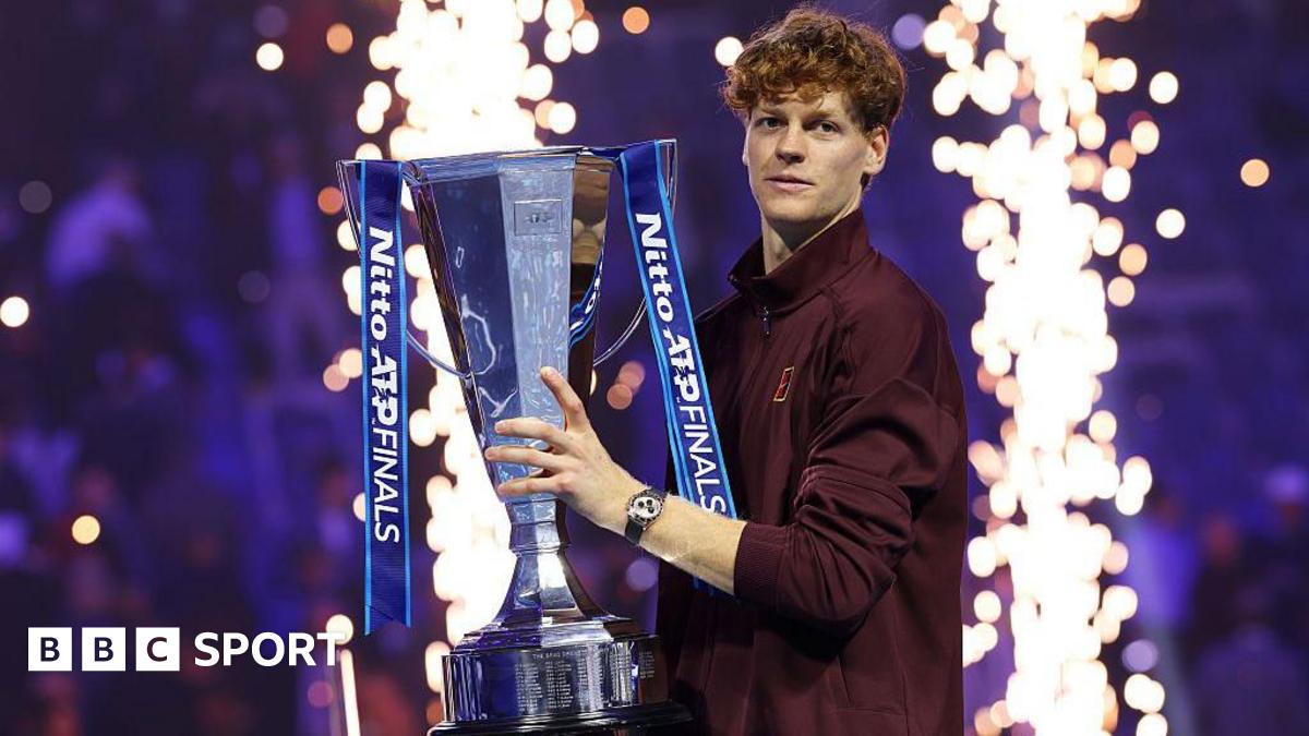Jannik Sinner poses with the ATP Finals trophy