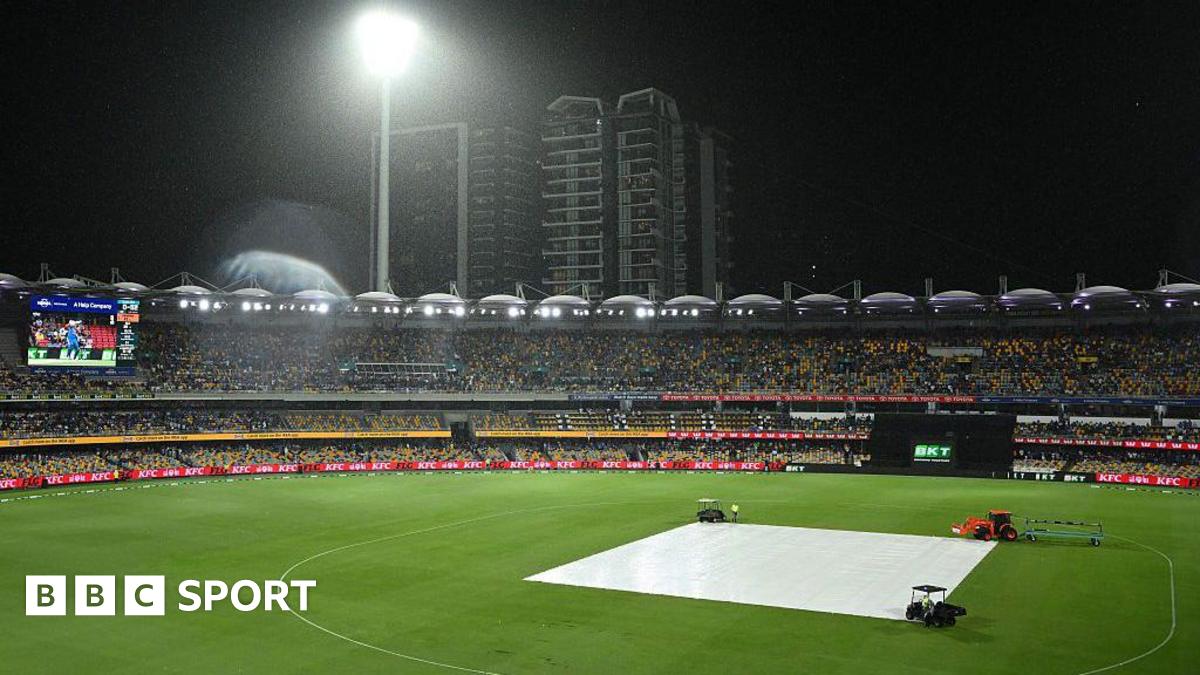 A general view of the Gabba in the rain with the covers on
