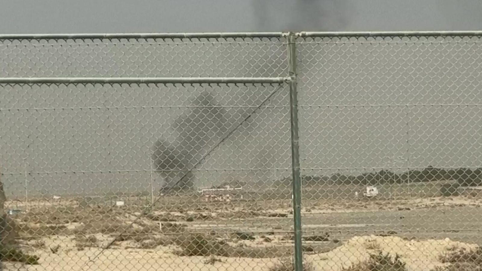 Smoke rises after the crash in Dubai. Pic: AP