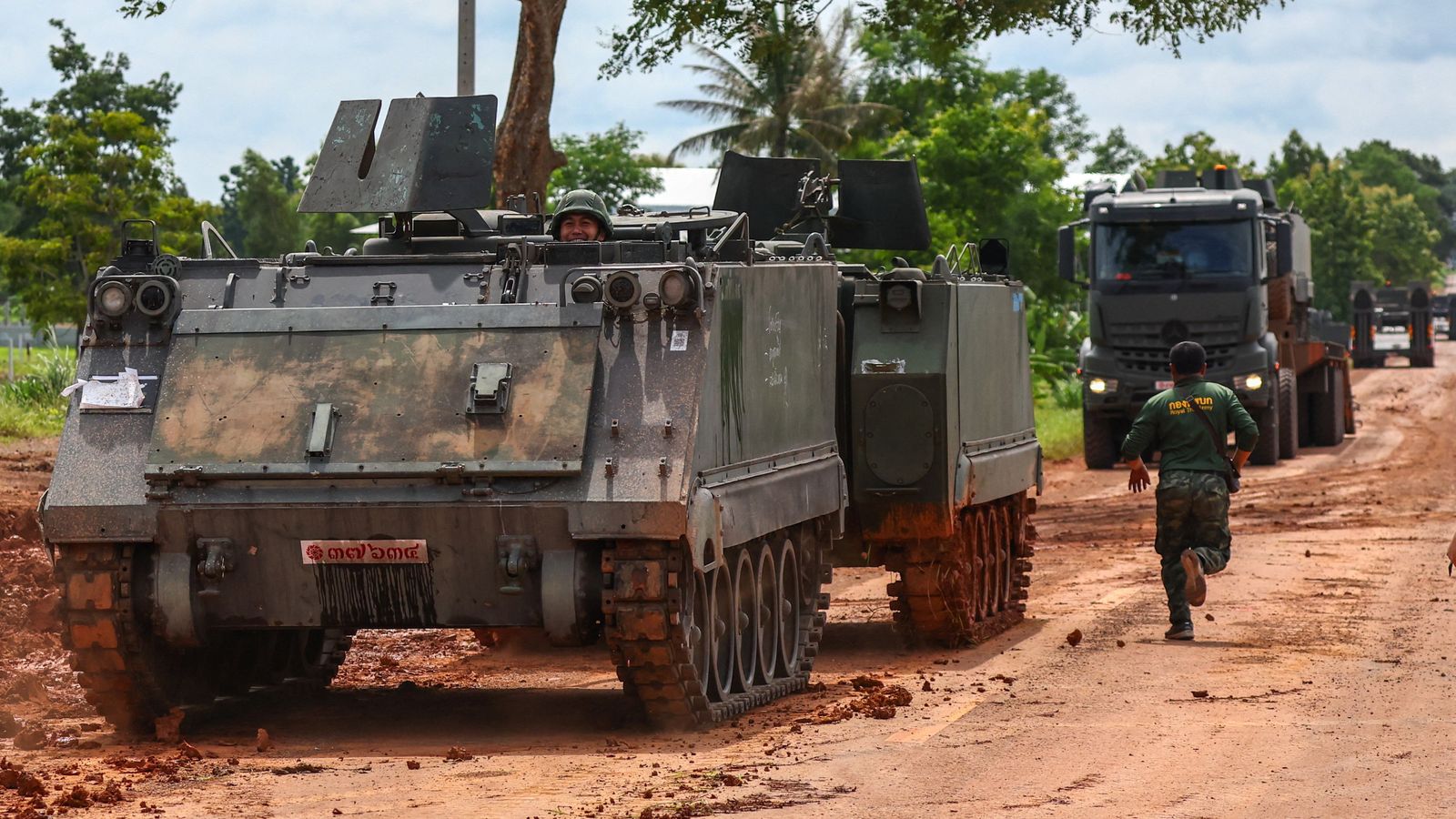 Armoured personnel carriers on a road near Thailand-Cambodia's border. Pic: Reuters