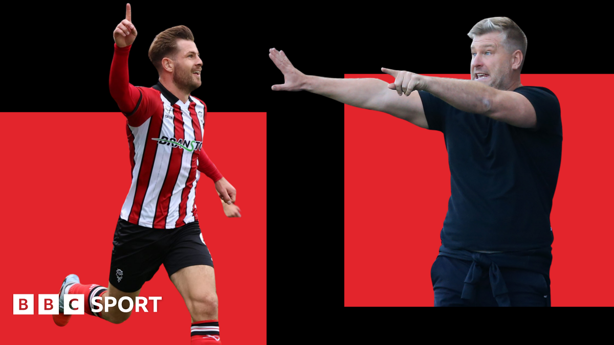 Lincoln striker James Collins celebrates while Salford City boss Karl Robinson gesticulates to his players