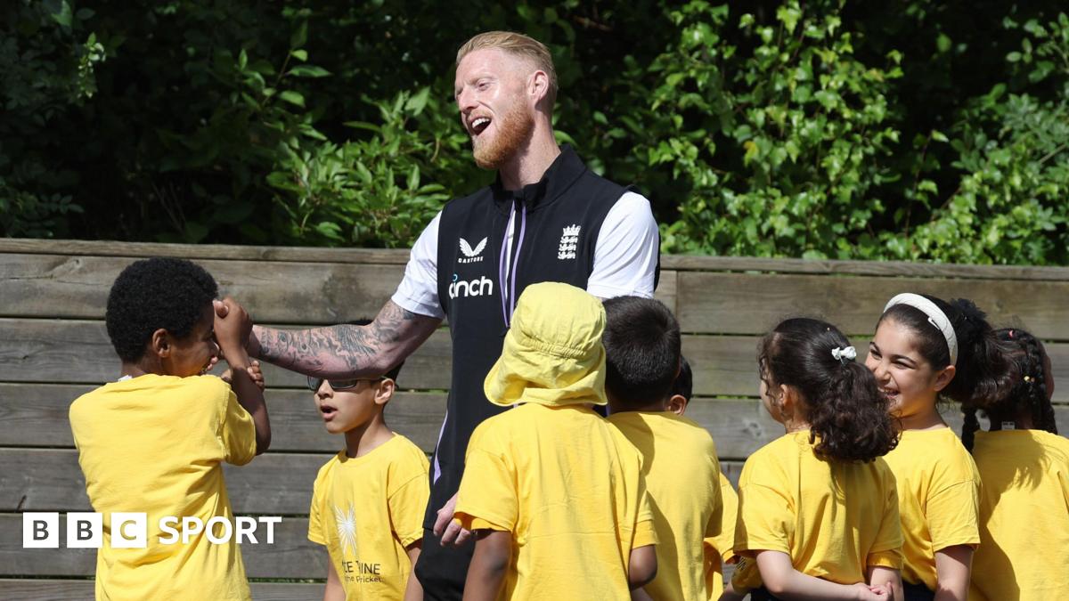 England captain Ben Stokes with some school children