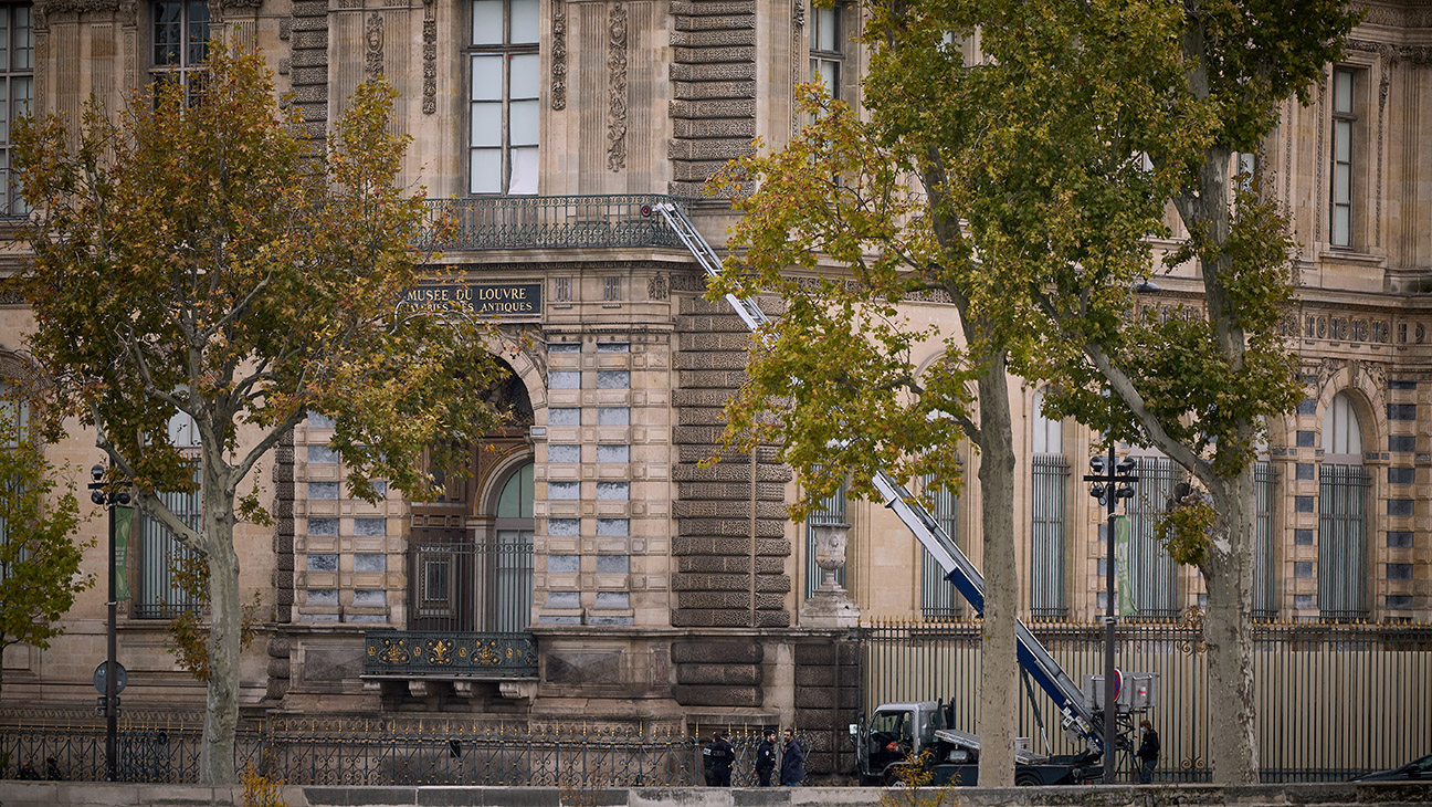 Police and Crime scene officers secure a furniture elevator extended to the balcony of a gallery at the Louvre Museum on October 19, 2025 in Paris, France.