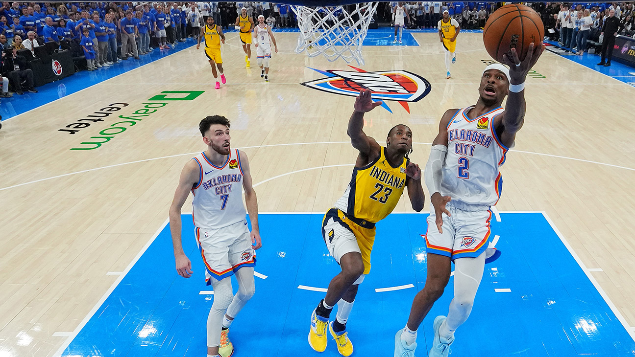 Shai Gilgeous-Alexander #2 of the Oklahoma City Thunder shoots a layup in front of Aaron Nesmith #23 of the Indiana Pacers as Chet Holmgren #7 of the Oklahoma City Thunder looks on during the fourth quarter in Game Five of the 2025 NBA Finals at Paycom Center on June 16, 2025 in Oklahoma City, Oklahoma.