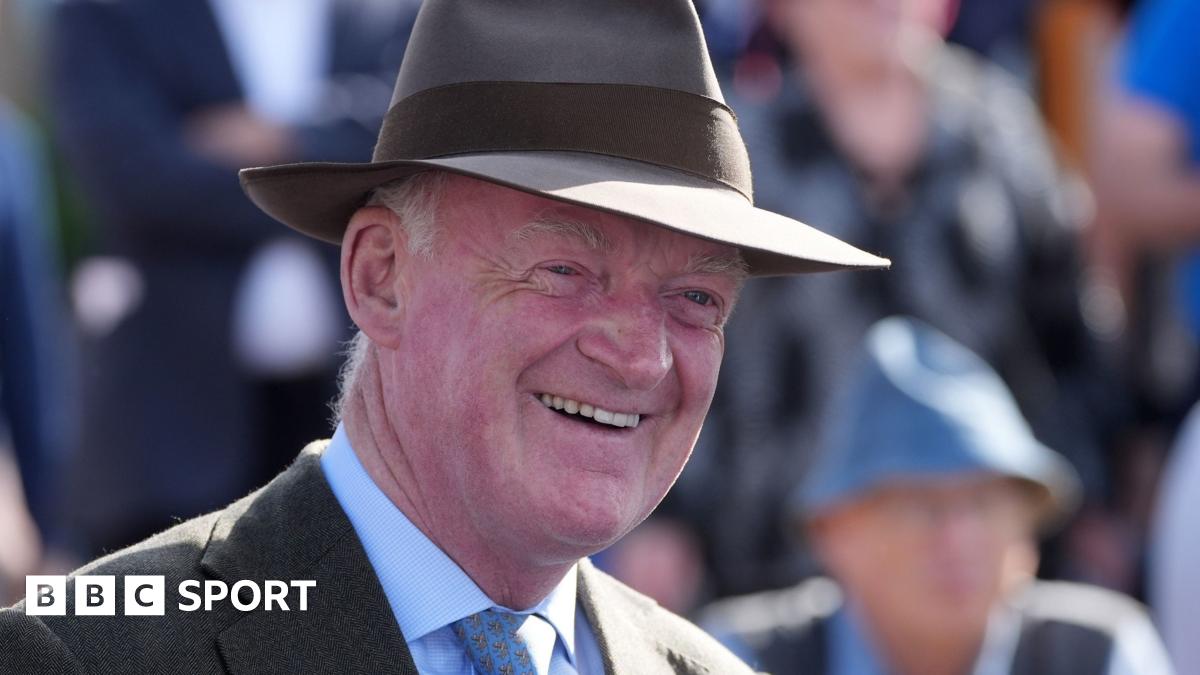 Willie Mullins smiles while wearing a hat