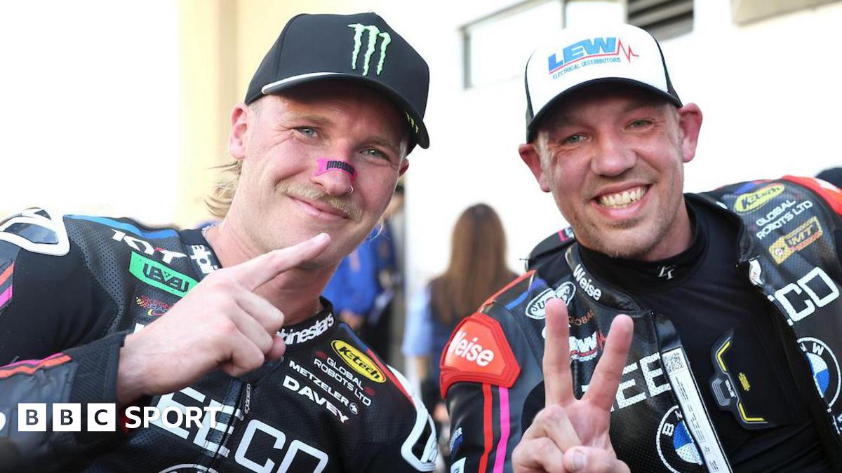 Davey Todd and Peter Hickman make hand gestures while posing for a photo