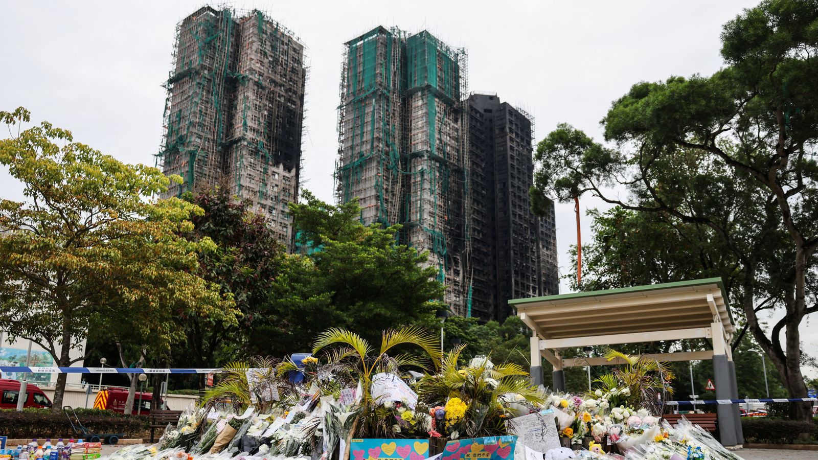 The burned towers and makeshift flower memorial today. Pic: Reuters