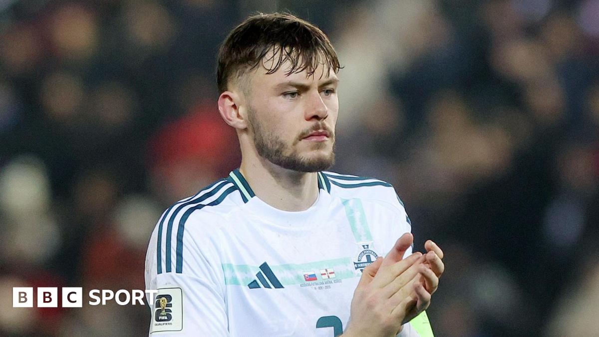 Conor Bradley applauds supporters in Kosice