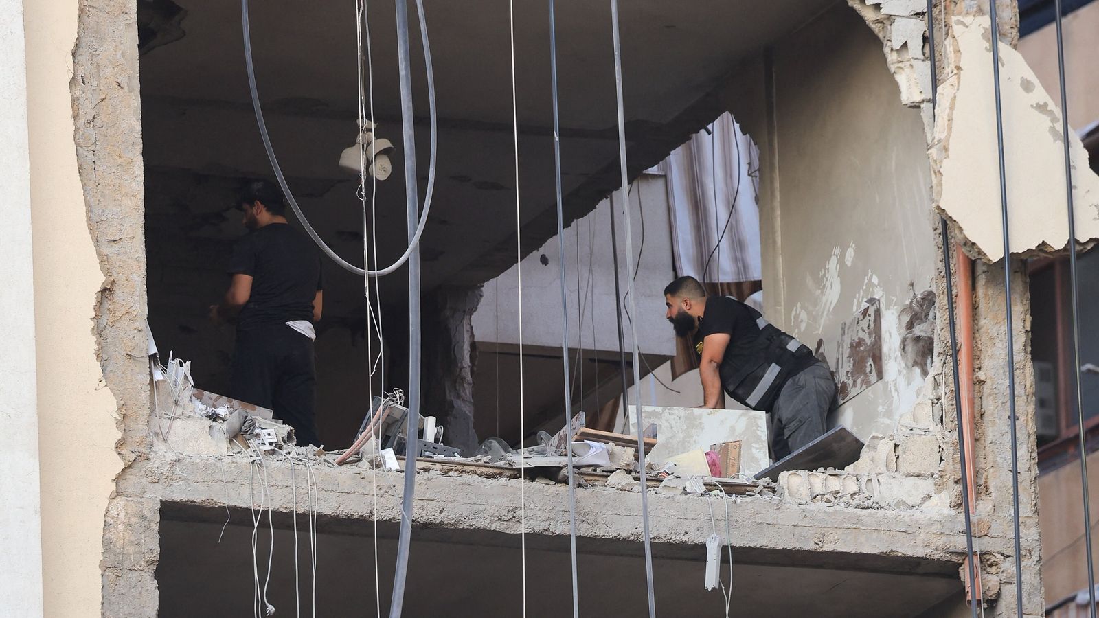 People inspect a damaged building after the strike. Pic: Reuters