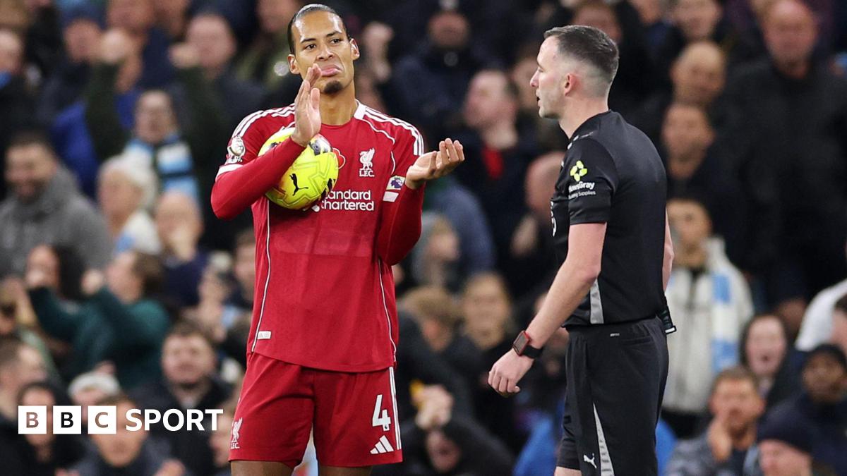 Liverpool defender Virgil van Dijk sarcastically applauds referee Chris Kavanagh