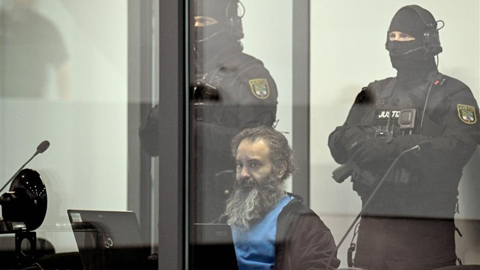 The suspect sat behind bulletproof glass. Pic: Reuters