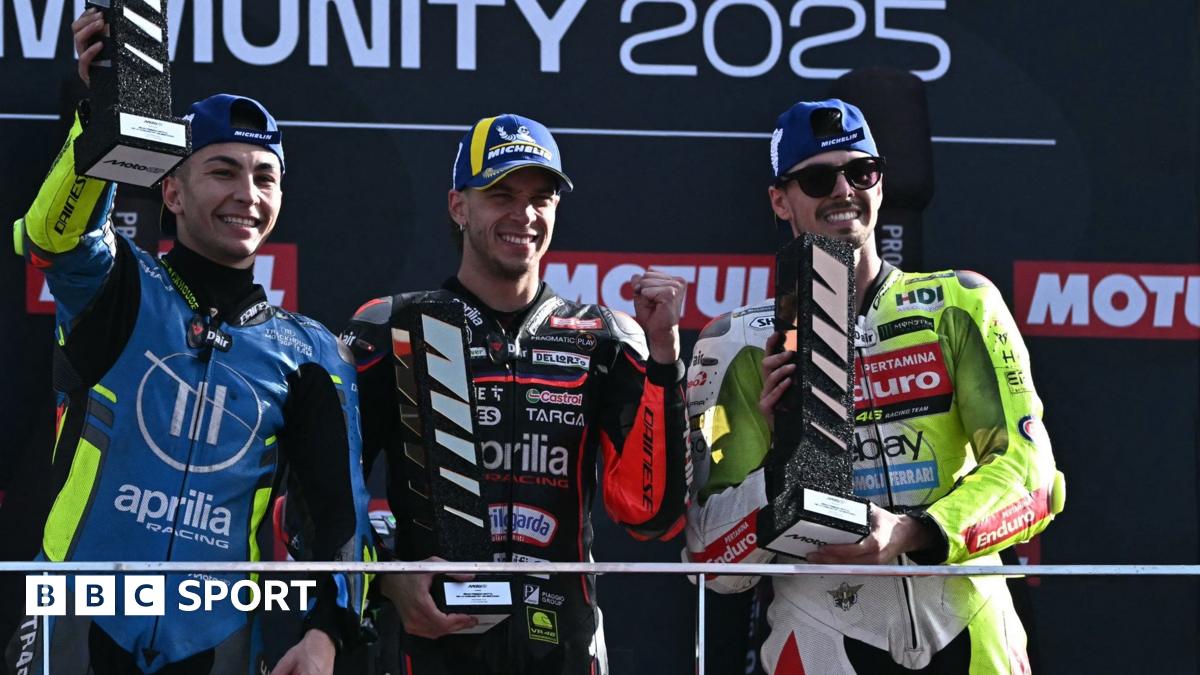 Marco Bezzecchi flanked by Raul Fernandez (left) and Fabio Di Giannantonio on the MotoGP podium in Valencia