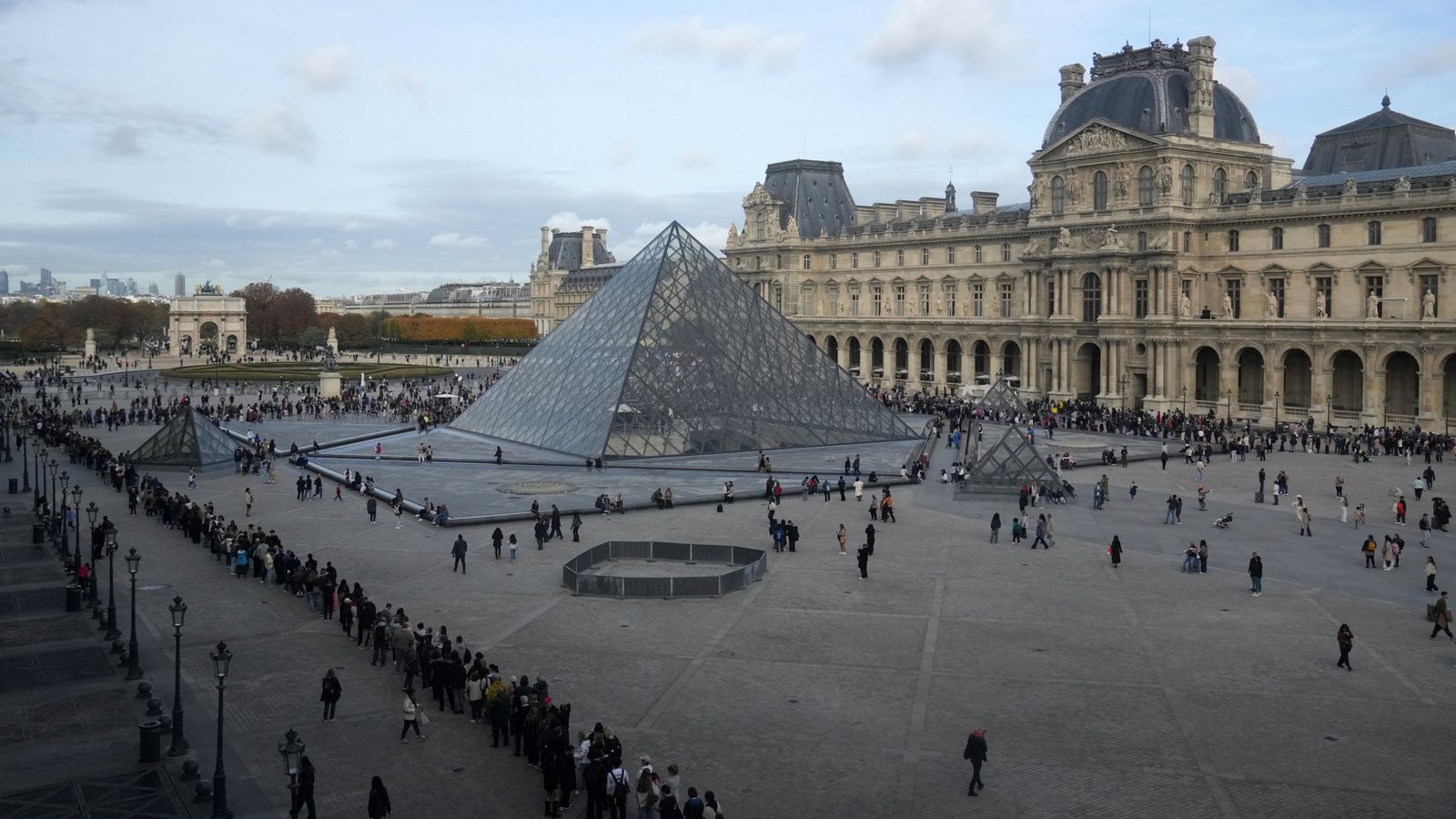 People queue outside the Louvre museum days after jewels were stolen. Pic: AP
