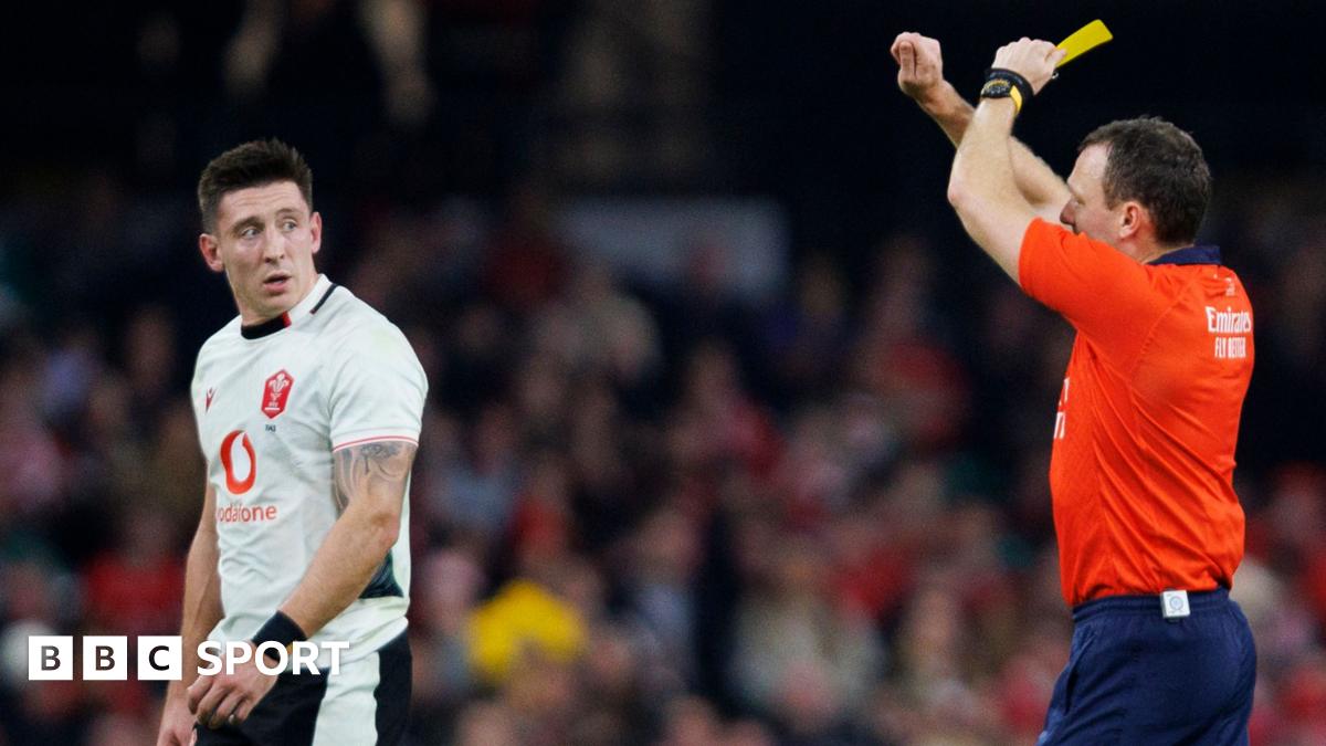 Wales wing Josh Adams is shown a yellow card by referee Matthew Carley that was upgraded to red