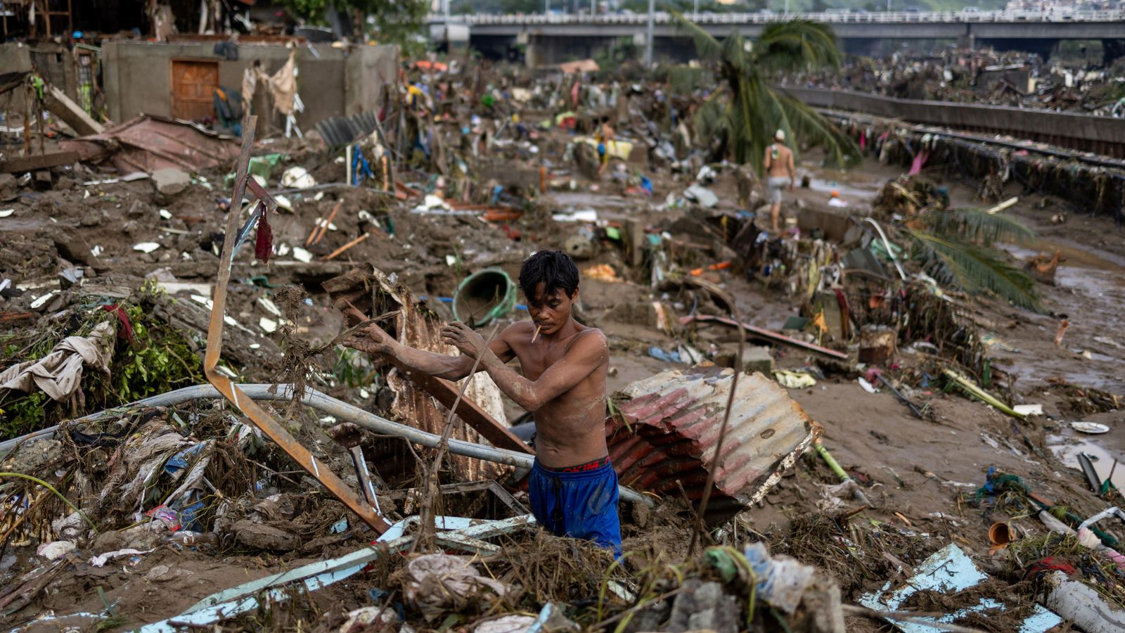 A man picks through the remains of his home after Typhoon Kalmaegi in Talisay, Cebu, Philippines. Pic: Reuters