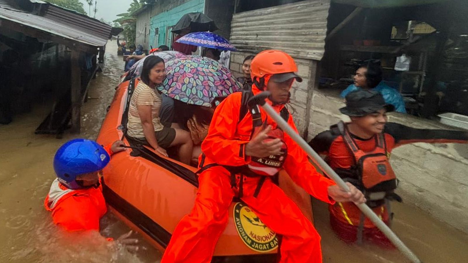 Residents are evacuated from their flooded home in North Sumatra province, Indonesia. Pic: AP