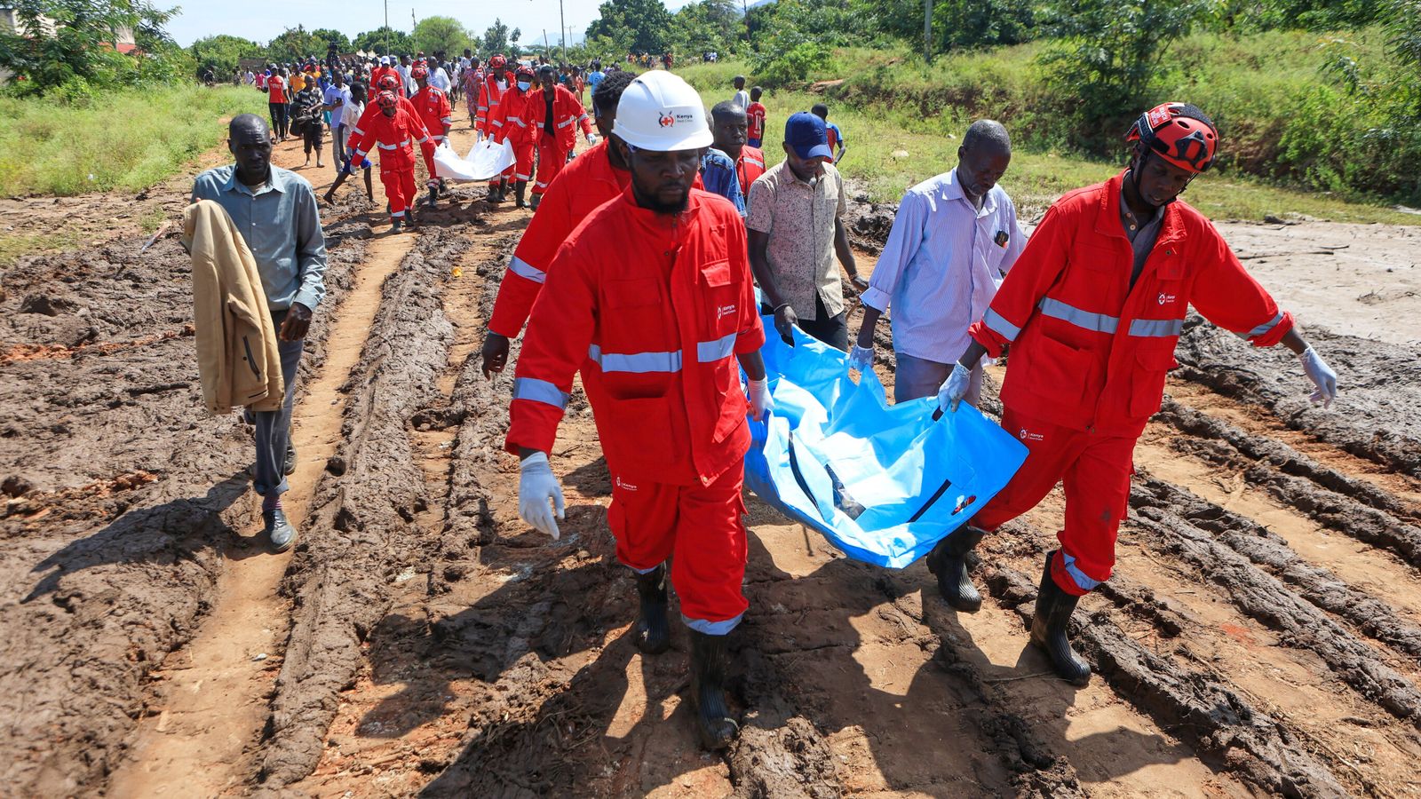 Rescue teams carry bodies of victims of a deadly landslide. Pic: AP/Andrew Kasuku
