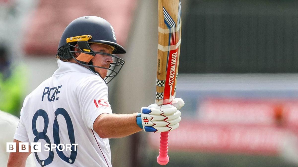 Ollie Pope raises his bat after reaching a milestone