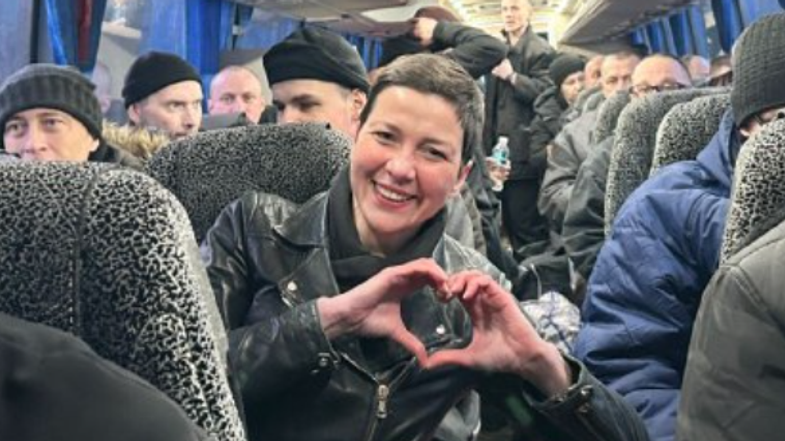 Maria Kolesnikova, making her trademark heart sign, on a coach with released prisoners arriving in Ukraine. Pic: Military Intelligence of Ukraine