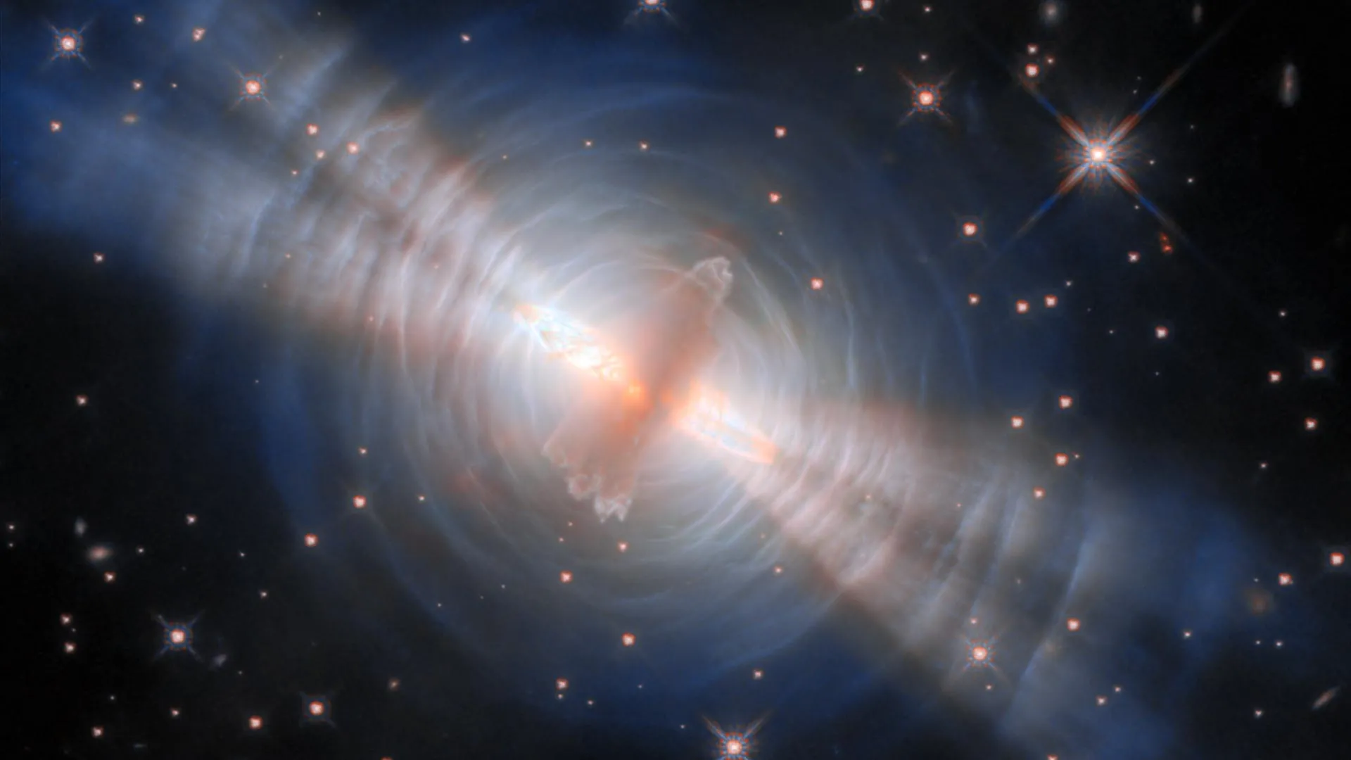Feixes gêmeos explodem de uma estrela escondida em imagem impressionante do Telescópio Espacial Hubble